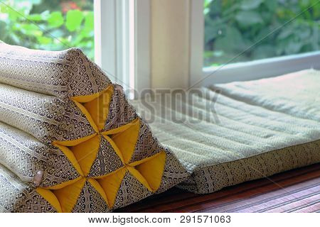 Triangle Backrest Pillow And Folding Mattress Prepared Closed To Window Exit Of Living Room To The O