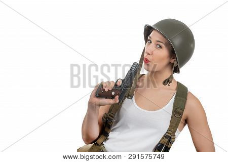 A Pretty Young Woman Dressed In Ww2 American Military Uniform With Helmet And Handgun