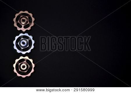 Color Rollers, Silver Gears For Bicycle Rear Derailleur On Black Background In Left Side, With Copys