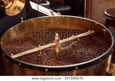 Roast Machine. The Freshly Roasted Coffee Beans From A Coffee Roaster Being Poured Into The Cooling 