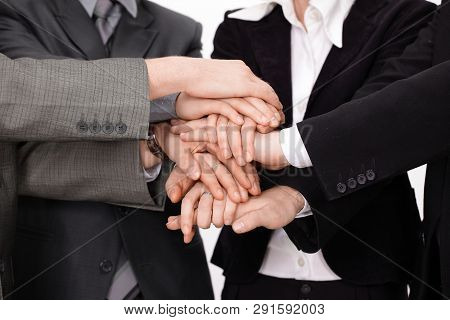 Group Of Business People With Hands Clasped Together.