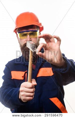 Builder, Master Clogs Nail. Repairman Using Hammer Clogs Nail. Bearded Man Clogs Nail With Hammer. C