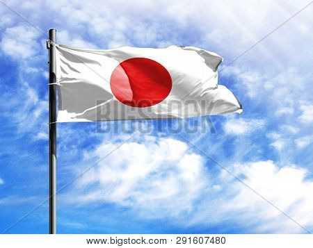 National Flag Of Japan On A Flagpole In Front Of Blue Sky.