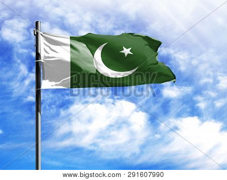 National Flag Of Pakistan On A Flagpole In Front Of Blue Sky.