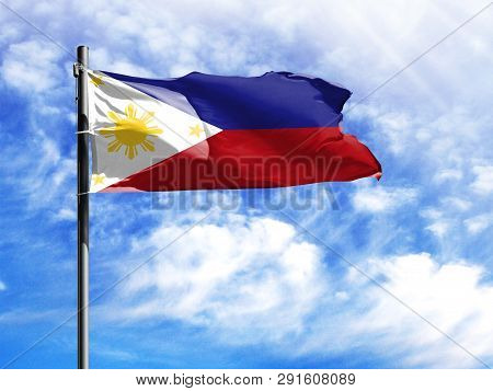 National Flag Of Philippines On A Flagpole In Front Of Blue Sky.