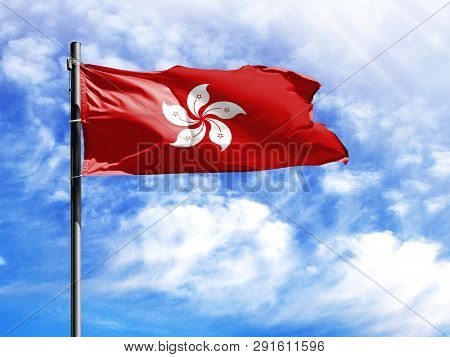 National Flag Of Hong Kong On A Flagpole In Front Of Blue Sky.