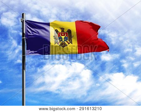 National Flag Of Moldova On A Flagpole In Front Of Blue Sky.
