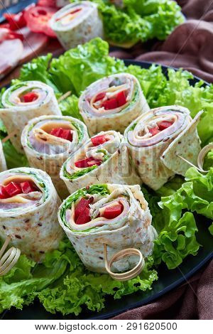 Sliced Sandwich Whole Grain Flatbread Wraps On A Skewers On A Plate. Ingredients And Garlic Sour Cre