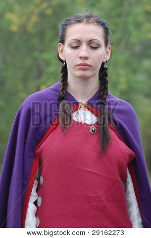 KIEV, UKRAINE - JULY 31: Member of history club Golden Capricorn wears medieval costume as she participates in historical festival in memory of King Vladimir July 31, 2009 in Kiev, Ukraine.