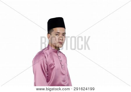 Portrait Of Young And Handsome Asian Man With Traditional Clothing During Hari Raya Over White Backg