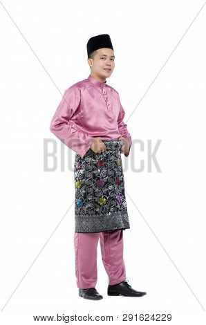 Portrait Of Young And Handsome Asian Man With Traditional Clothing During Hari Raya Over White Backg
