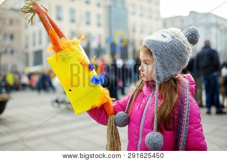 Cute Girl Wearing Frightening Masks During The Celebration Of Uzgavenes, A Lithuanian Annual Folk Fe
