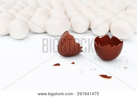 One Chocolate Egg Broken On Two Pieces. Chocolate Egg Around White Eggs, Concept Individuality, Excl