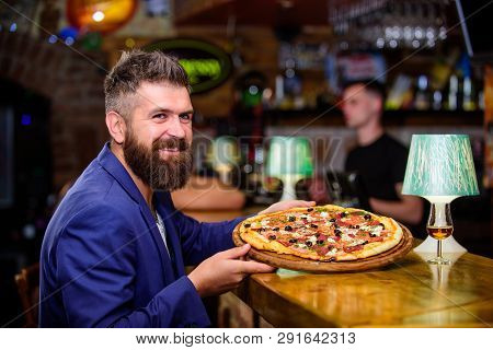 Hipster Client Sit At Bar Counter. Man Received Delicious Pizza. Enjoy Your Meal. Cheat Meal Concept