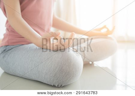 Close Up Hand And Half Body Of Healthy Woman Sit In Lotus Yoga Position.young Healthy Woman Sitting 
