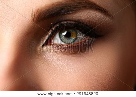 Female Left Emerald Green Coloured Eye Extreme Closeup. Low Light Technique Oculist And Perfect Visi