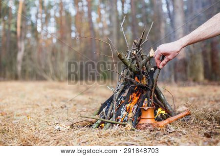 At The Stake In The Spring Forest, A Clay Turkish Coffee Pot Is Heated Against The Grass. In The Fra