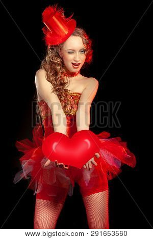 Sexy Burlesque Dancer Stripper Posing With Sweet Lollipop, In Red Corset And Red Hat With Curly Hair