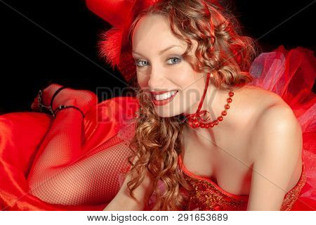Sexy Burlesque Dancer Stripper Posing With Sweet Lollipop, In Red Corset And Red Hat With Curly Hair