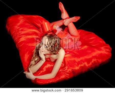 Sexy Burlesque Dancer Stripper Posing With Sweet Lollipop, In Red Corset And Red Hat With Curly Hair