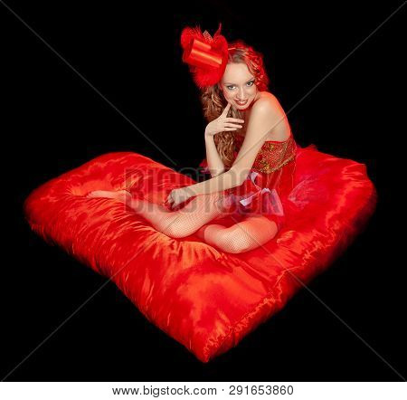 Sexy Burlesque Dancer Stripper Posing With Sweet Lollipop, In Red Corset And Red Hat With Curly Hair