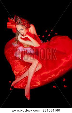 Sexy Burlesque Dancer Stripper Posing With Sweet Lollipop, In Red Corset And Red Hat With Curly Hair