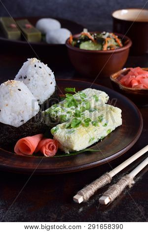 Mix Of Japanese Food - Rice Balls Onigiri, Omelette, Ginger, Sunomono Wakame Cucumber Salad. Traditi
