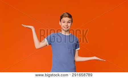 Hesitant Boy Spreading Hands Sideways, Making Choice Or Decision, Cannot Choose, Orange Background W