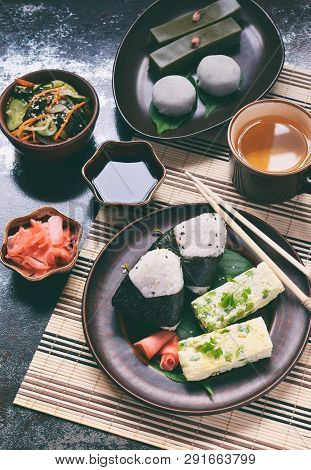 Mix Of Japanese Food - Rice Balls Onigiri, Omelette, Ginger, Sunomono Wakame Cucumber Salad. Traditi