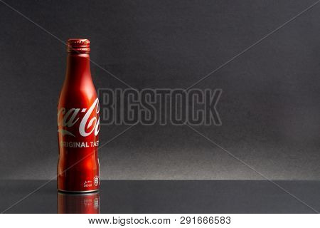 Kuala Lumpur, Malaysia - March 18,2019: A Bottle Of Coca Cola Drink Isolated Over A Dark  Background