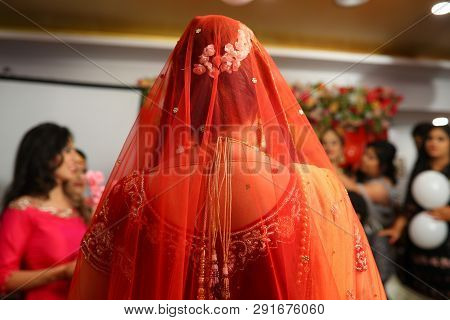 Beautiful Indian Bride In Traditional Outfit Red Dupatta And Red Blouse, Beautiful Hair Bun With Whi