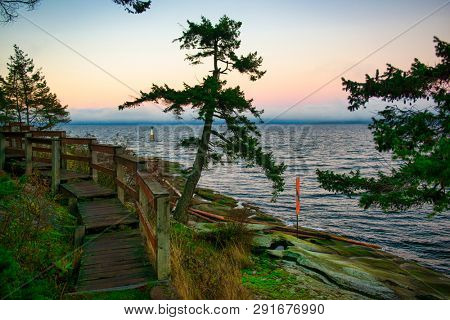 Scenic sunset view of the ocean overlooking the Strait of Georgia from Jack Point Park in Nanaimo, British Columbia.