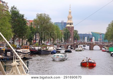 Amsterdam, Netherlands - July 8, 2017:  Boats On Oudeschans Canal In Amsterdam, Netherlands. Amsterd