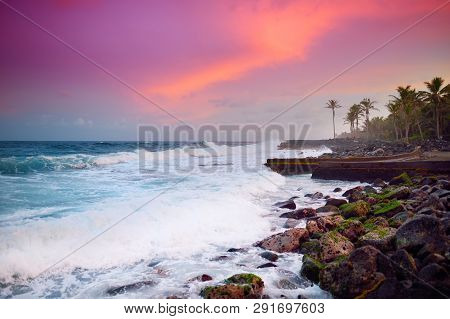 Beautiful Pink Tinted Waves Breaking On A Rocky Beach At Sunrise On East Coast Of Big Island Of Hawa