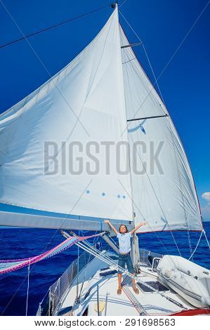 Little Boy On Board Of Sailing Yacht On Summer Cruise. Travel Adventure, Yachting With Child On Fami