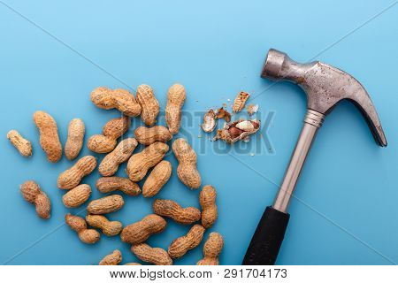 Natural Whole Peanuts In A Shell  On A Blue Background.peel The Peanut From The Shell.healthy Vegan 