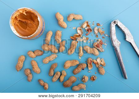 Natural Whole Peanuts In A Shell  On A Blue Background.healthy Vegan Food Concept. Flat Lay, Top Vie