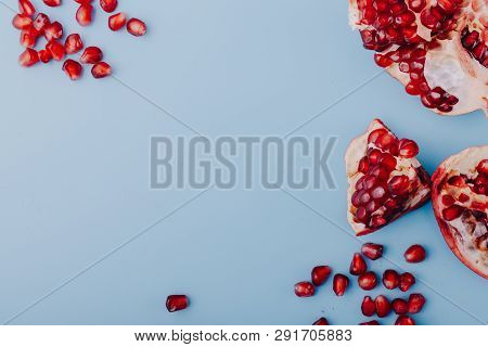 Garnet Background. Ripe Red Garnet Fruit. Garnet Fruit Slices On A Blue Background. Vegetarian Conce