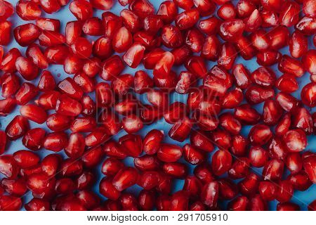 Garnet Background. Ripe Red Garnet Fruit. Garnet Fruit Slices On A Blue Background. Vegetarian Conce