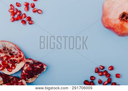 Garnet Background. Ripe Red Garnet Fruit. Garnet Fruit Slices On A Blue Background. Vegetarian Conce