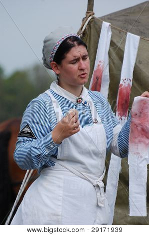KIEV, UKRAINE - MAY 10 : member of Red Star history club wears historical military German paramedic uniform during historical reenactment of 1945 WWII, May 10, 2010 in Kiev, Ukraine.