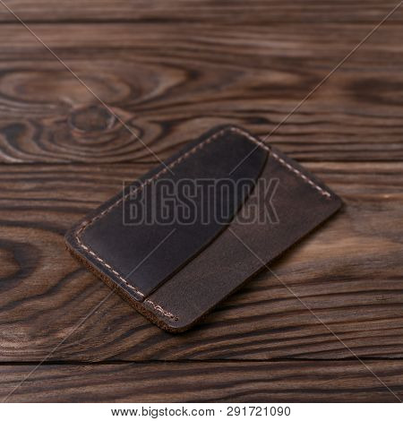 Brown Colour Handmade Leather One Pocket Cardholder On Wooden Background. Stock Photo With Soft Blur