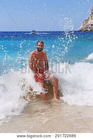 Brunette Man Getting Hit By The Big Waves At Erimitis Beach Paxos Greece