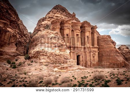 View of the legendary monastery hidden by the rocky hills where it is excavated. Built by the Nabataeans and located in the suggestivecity ??of Petra, Jordan.