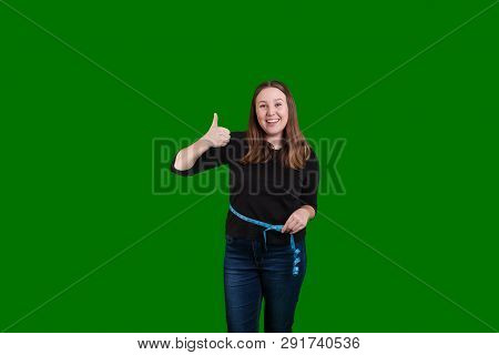 Women Giving A Thumbs Up Smiling Meassuring Her Waist With A Blue Rolling Tape Measurer