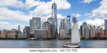 Manhattan Skyline In New York City As Seen From The Harbor With A White Sailboat In Foreground. Whit