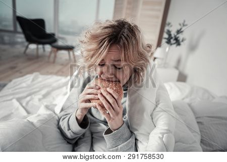 Woman Biting Burger While Eating Too Much In Depression