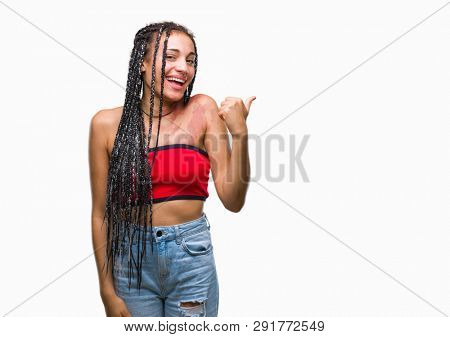 Young braided hair african american with pigmentation blemish birth mark over isolated background doing happy thumbs up gesture with hand. Approving expression looking at the camera