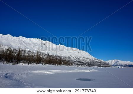 Blue Sky And White Mountain In Alaska