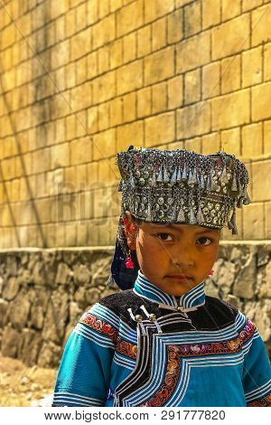 Yuanyang County, Yunnan, China - 2014: A Hani Minority Village Girl Wearing Traditional Headgear Ado